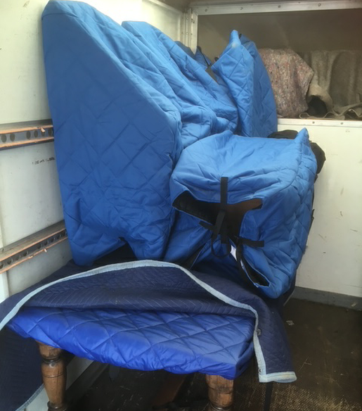 An Image of an organ and antiques table  securely wrapped for transport